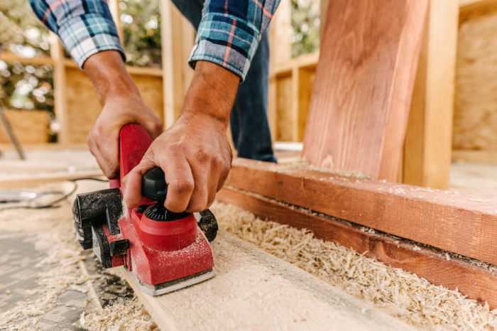 https://hillcrestpaintingandflooringservices.com.au/wp-content/uploads/2025/06/construction-worker-sanding-down-wood.jpg