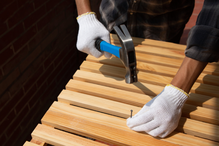 https://hillcrestpaintingandflooringservices.com.au/wp-content/uploads/2025/06/construction-worker-using-hammer-job.jpg